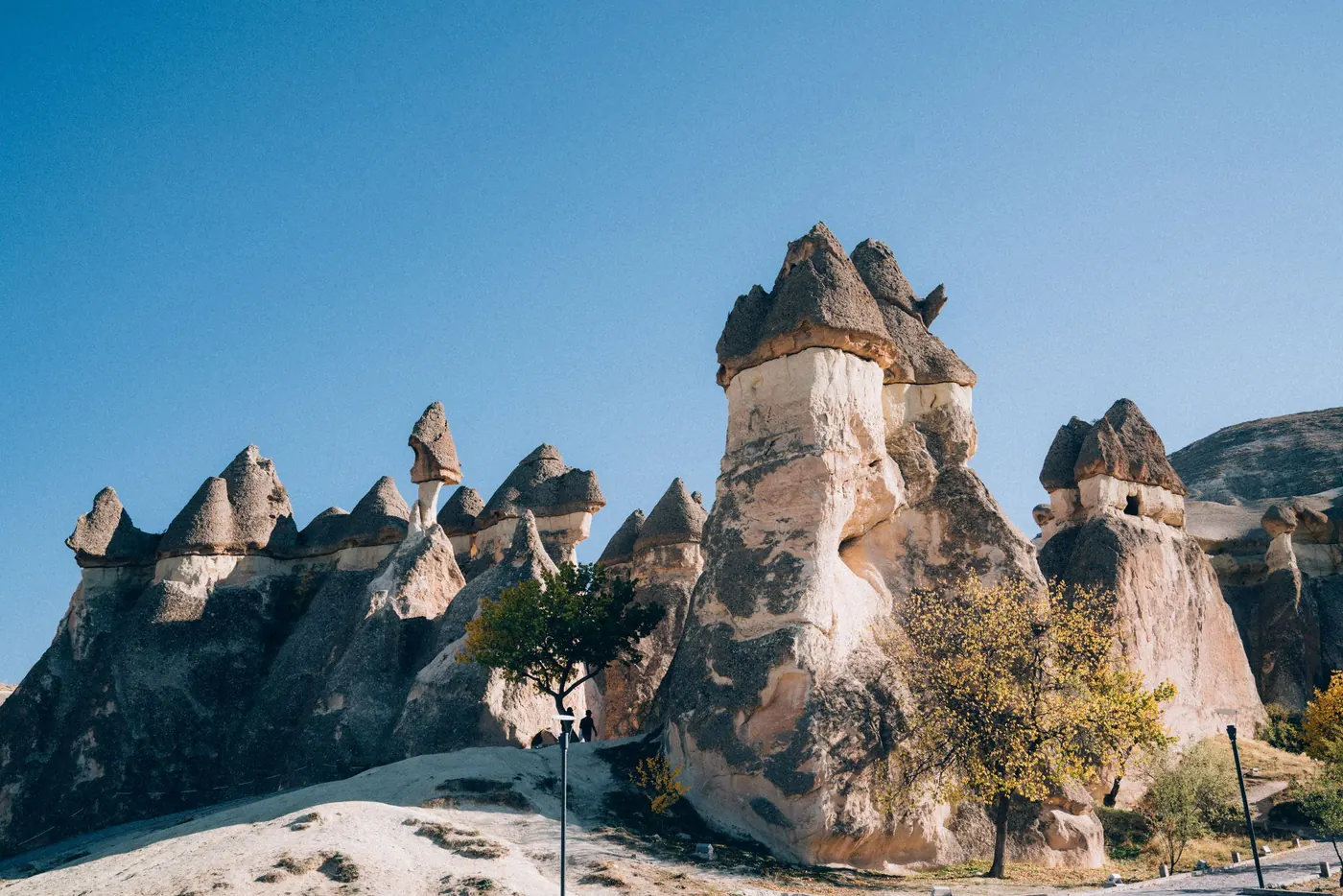 Fairy chimney rock formations in Paşabağ valley, Cappadocia, under a clear blue sky
