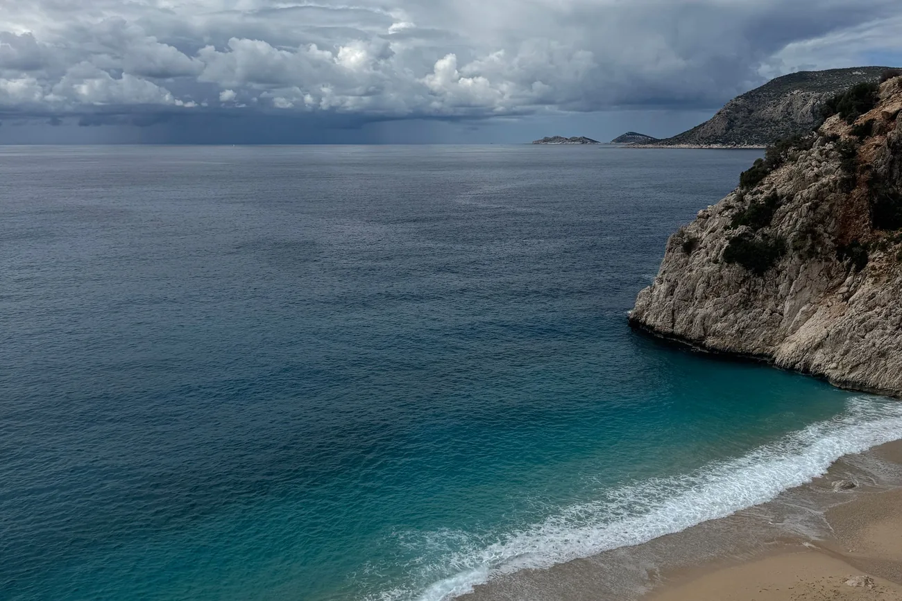 Waves rolling onto Kaputaş beach below limestone cliffs on the Lycian coast